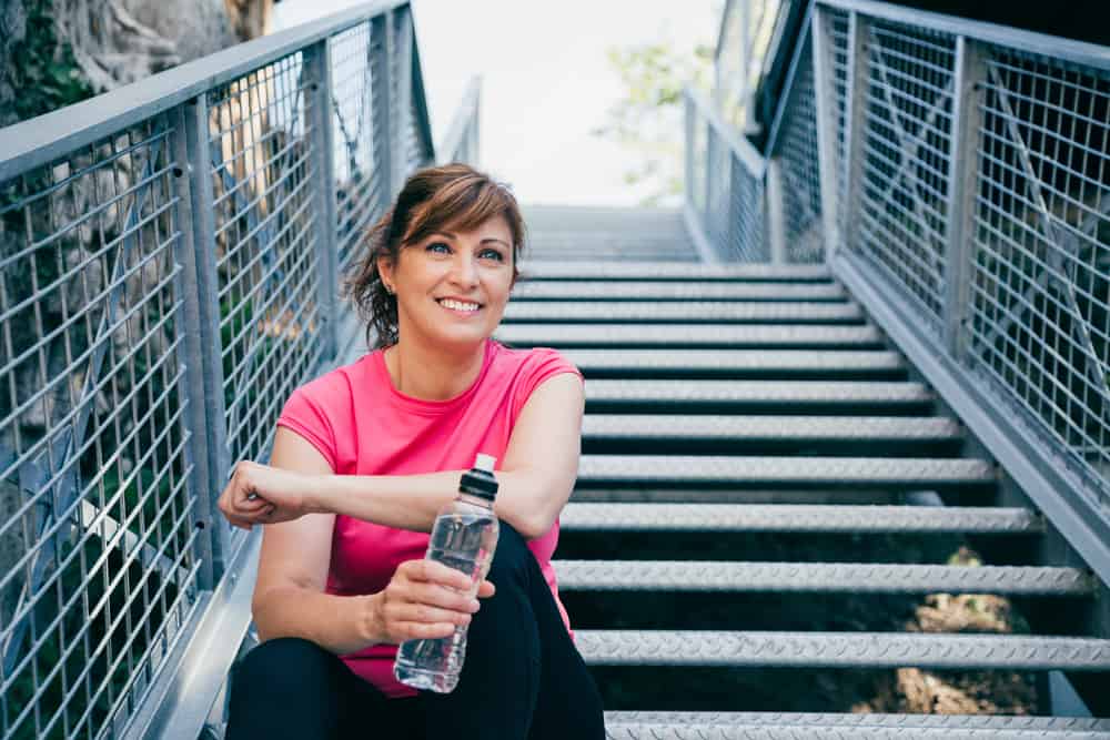 Woman exercising to combat menopause belly.